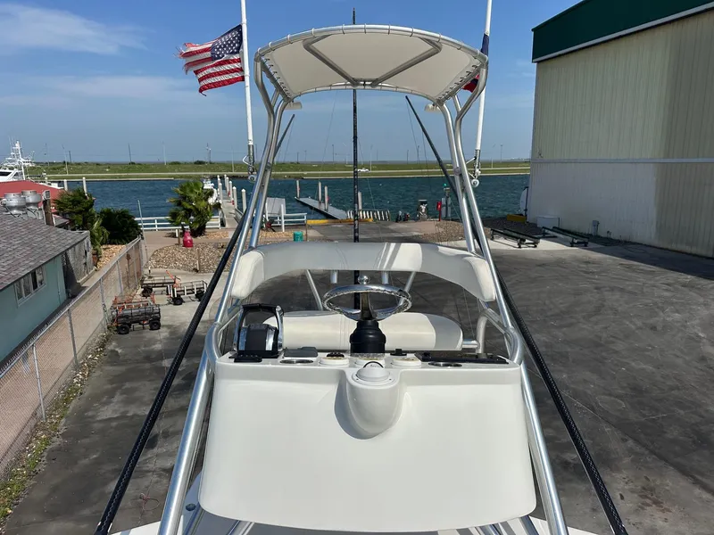 Slide: The Image of 2013 SeaVee 390B boat helm with American flag, dockside view. - 22