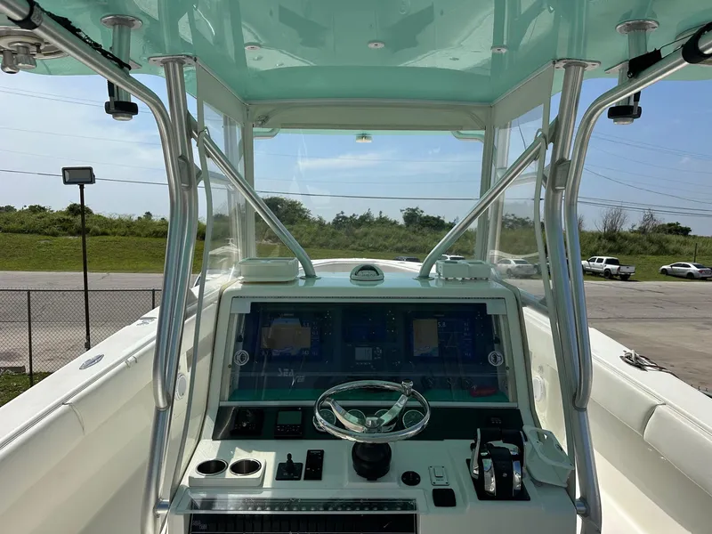 Slide: The Image of 2013 SeaVee 390B boat helm with modern controls and steering wheel. - 5