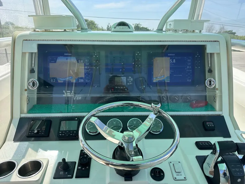 Slide: The Image of 2013 SeaVee 390B boat dashboard with steering wheel and navigation displays. - 7