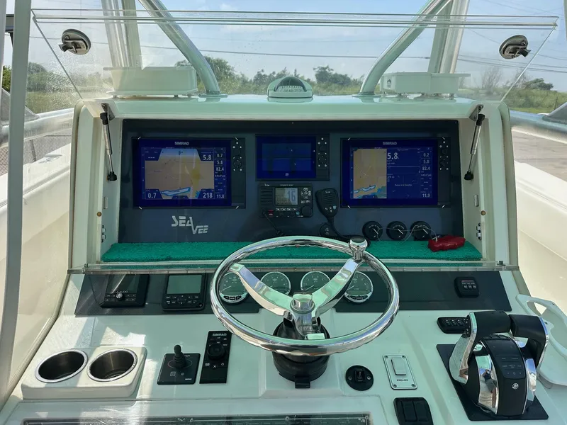 Slide: The Image of 2013 SeaVee 390B boat dashboard with navigation screens and steering wheel. - 8