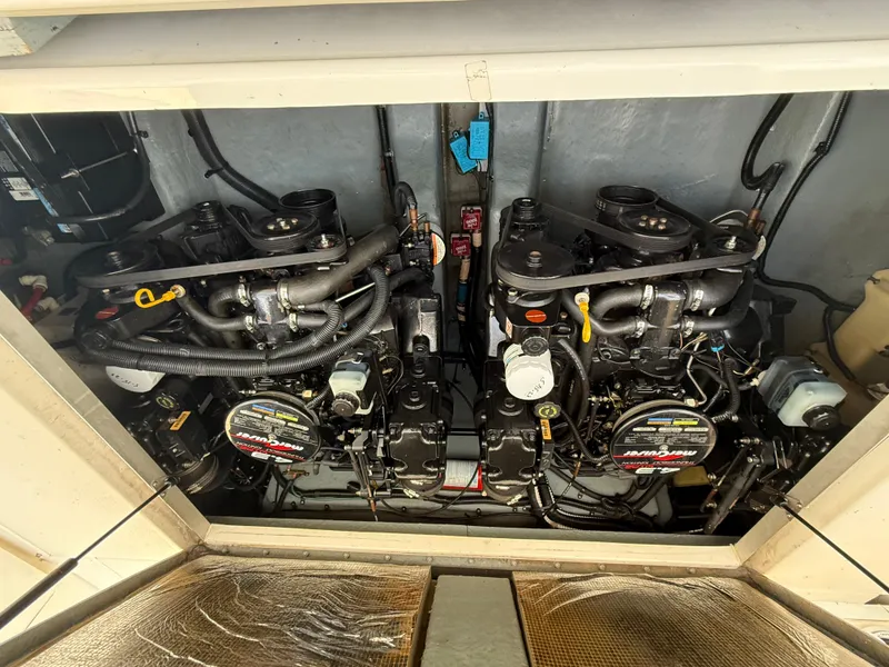 Slide: The Image of Engine compartment of a 1997 Sea Ray 290 Sundancer boat, featuring dual engines. - 12