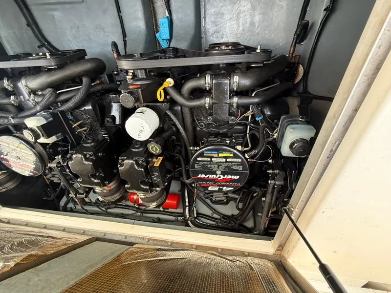 Slide: The Image of Engine compartment of a 1997 Sea Ray 290 Sundancer boat, featuring dual MerCruiser engines. - 13