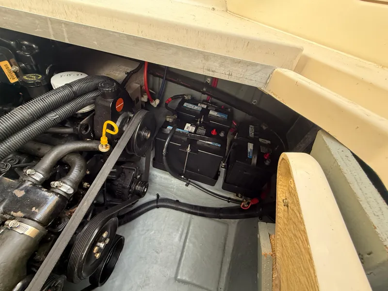 Slide: The Image of Engine compartment of a 1997 Sea Ray 290 Sundancer with visible batteries and components. - 14