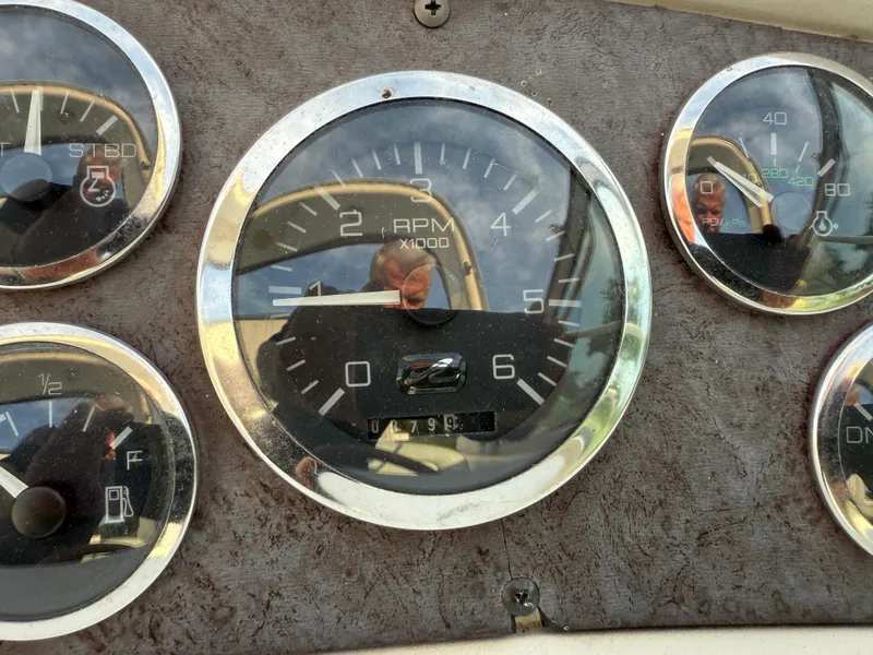 Slide: The Image of Dashboard gauges of a 1997 Sea Ray 290 Sundancer boat. - 18