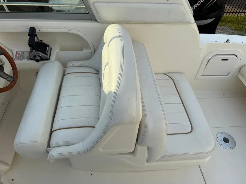 Slide: The Image of 1997 Sea Ray 290 Sundancer boat interior with white leather seating and control panel. - 21