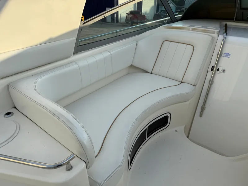 Slide: The Image of 1997 Sea Ray 290 Sundancer interior with white leather seating. - 22