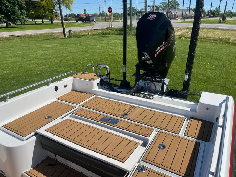 Slide: The Image of Charger VMAG 2010 boat deck with motor, 2022 model, featuring wood paneling. - 10