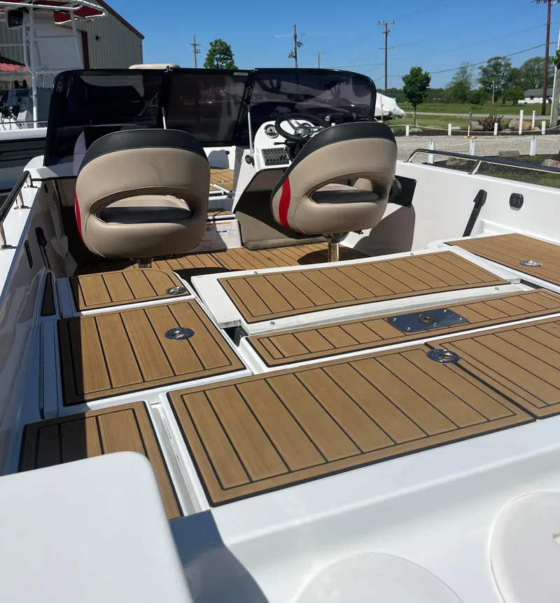 Slide: The Image of Charger VMAG 2010 boat interior, 2022 model, featuring sleek seating and wooden deck panels. - 11