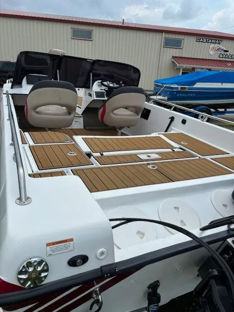 Slide: The Image of 2022 Charger VMAG 2010 boat with wooden deck and dual seats, displayed outdoors. - 8