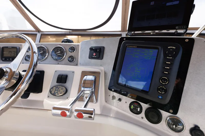 Slide: The Image of Control panel of 2003 Regal Commodore 3880 boat with navigation instruments and steering wheel. - 16