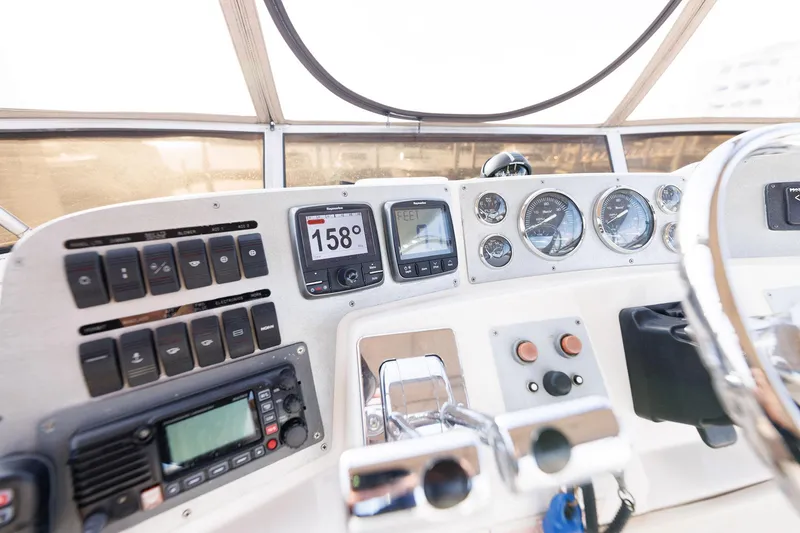 Slide: The Image of Control panel of a 2003 Regal Commodore 3880 boat with navigation instruments and gauges. - 21