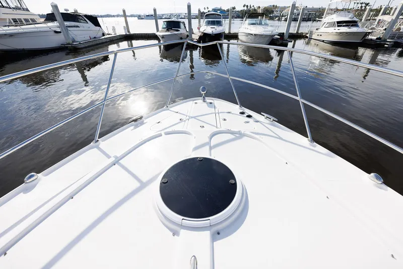 Slide: The Image of Bow view of 2003 Regal Commodore 3880 yacht docked at marina. - 26