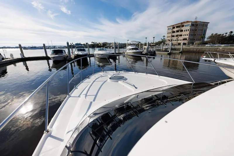 Slide: The Image of 2003 Regal Commodore 3880 yacht docked at marina with waterfront view. - 28