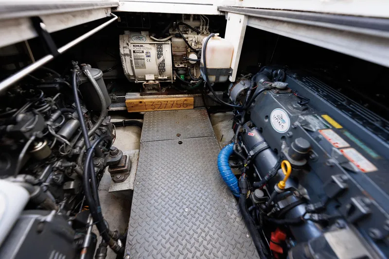 Slide: The Image of Engine room of 2003 Regal Commodore 3880 boat, showcasing mechanical components and generator. - 34