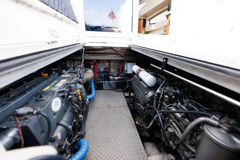 Slide: The Image of Engine room of 2003 Regal Commodore 3880 yacht, showcasing dual engines and mechanical components. - 35