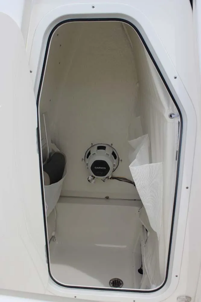 Slide: The Image of 2025 Key West 239 FSR boat storage compartment with speaker and drain. - 10