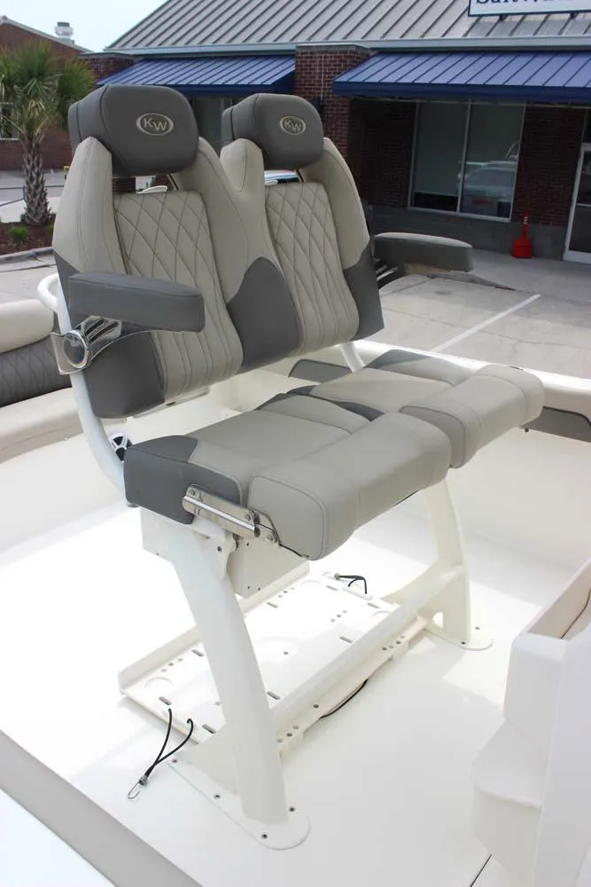 Slide: The Image of 2025 Key West 239 FSR boat seats with gray upholstery and armrests, displayed outdoors. - 15