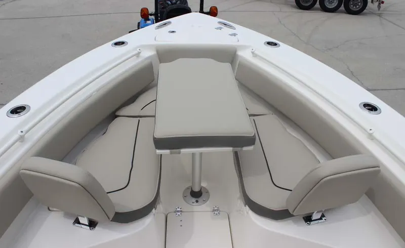 Slide: The Image of 2025 Key West 239 FSR boat interior with cushioned seating and table. - 17