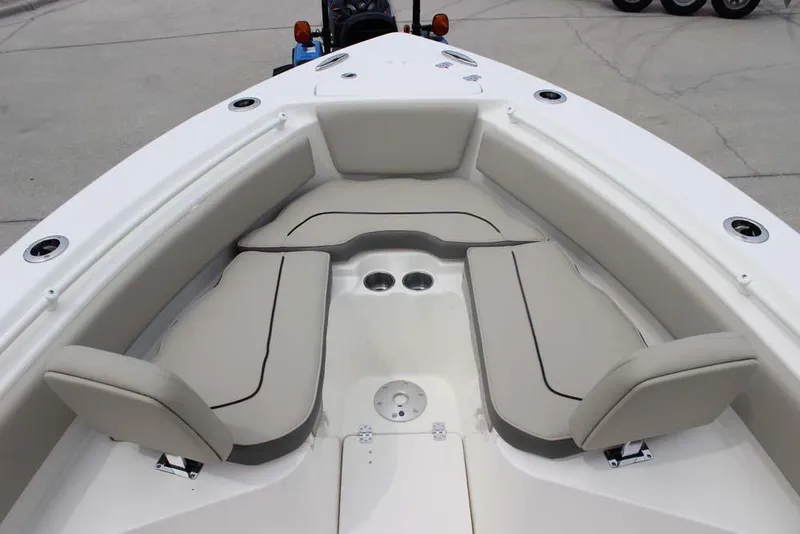 Slide: The Image of 2025 Key West 239 FSR boat interior with cushioned seating and cup holders. - 19