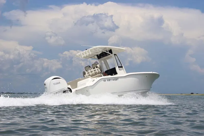 Slide: The Image of 2025 Key West 239 FSR boat cruising on open water under a cloudy sky. - 2