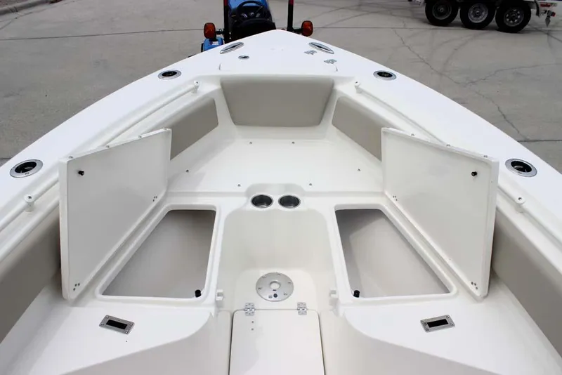 Slide: The Image of 2025 Key West 239 FSR boat interior with open storage compartments and cup holders. - 21
