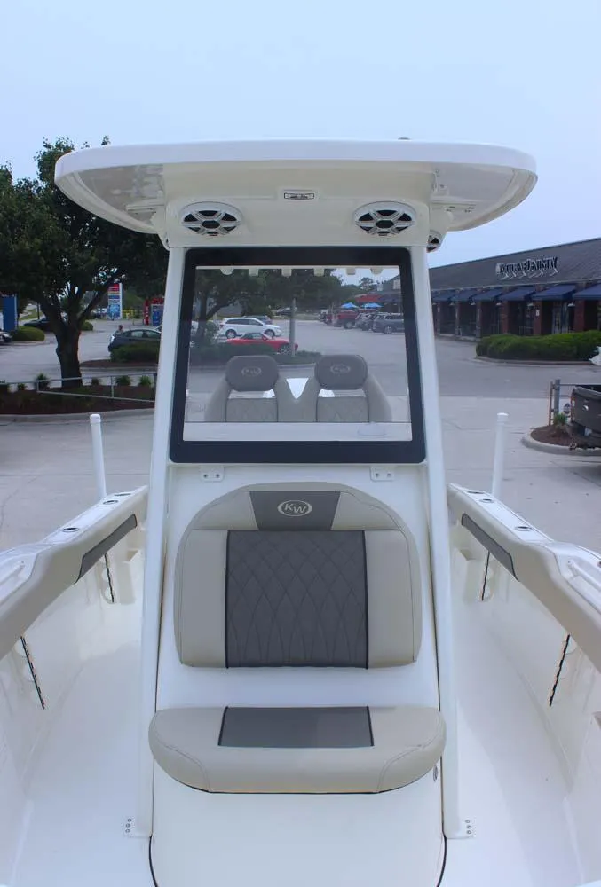 Slide: The Image of 2025 Key West 239 FSR boat with seating and console, parked in a lot. - 23