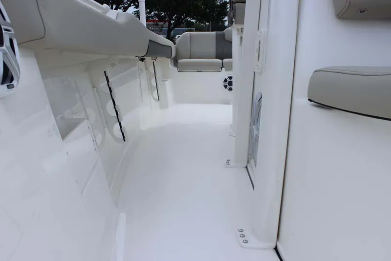 Slide: The Image of 2025 Key West 239 FSR boat interior with white deck and cushioned seating. - 25