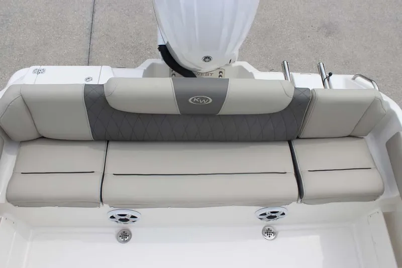 Slide: The Image of 2025 Key West 239 FSR boat seating with gray and beige cushions, featuring built-in speakers. - 26