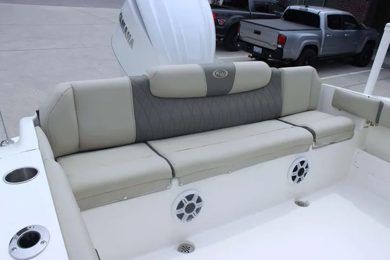 Slide: The Image of 2025 Key West 239 FSR boat with beige seating and built-in speakers. - 27