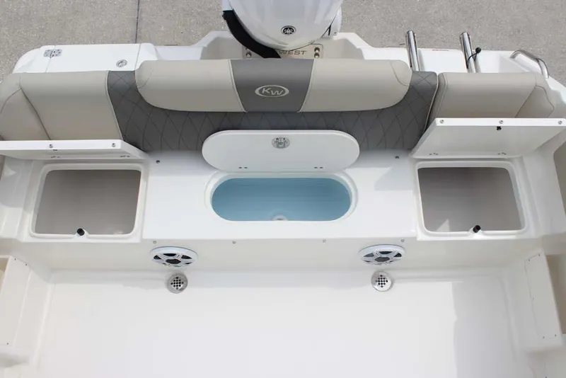 Slide: The Image of 2025 Key West 239 FSR boat interior with seating, storage, and speakers. - 29