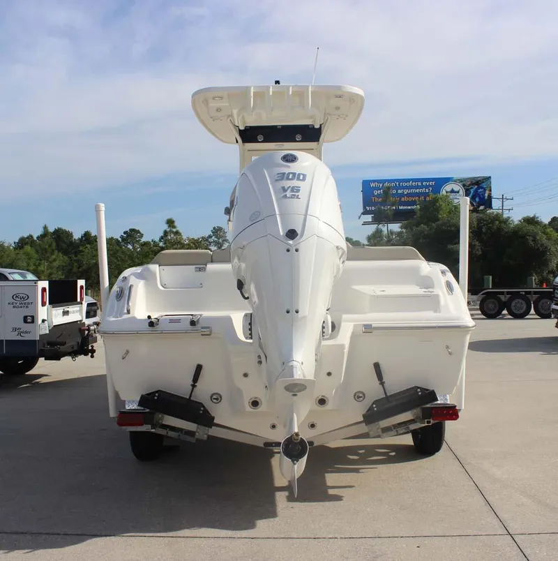 Slide: The Image of 2025 Key West 239 FSR boat with powerful outboard motor, parked outdoors. - 5