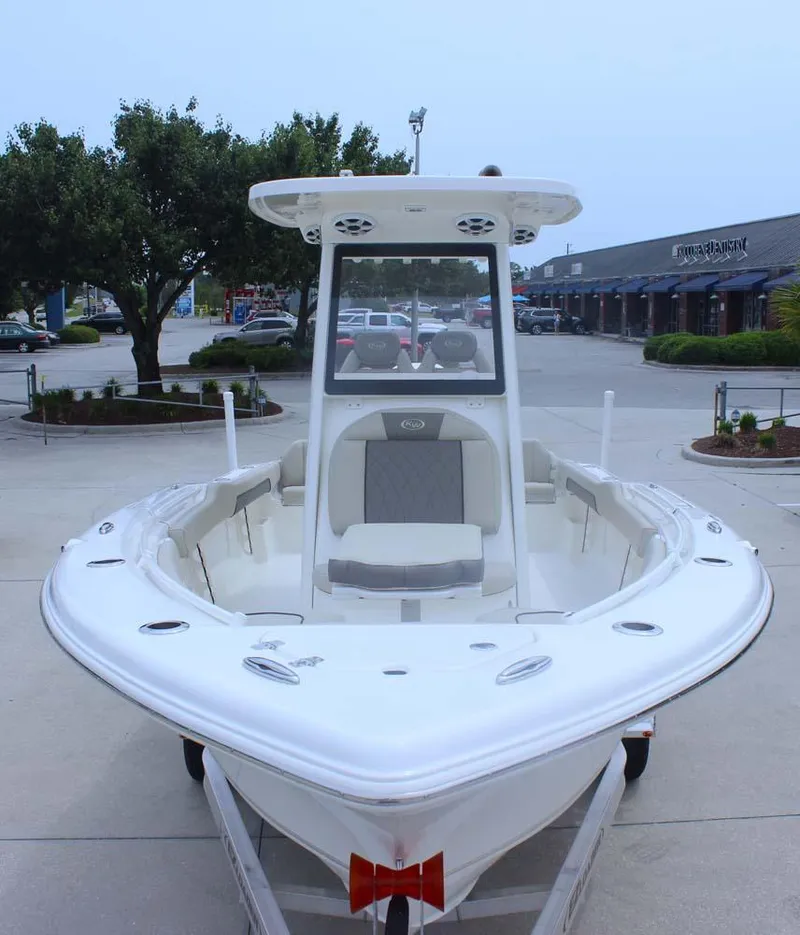 Slide: The Image of 2025 Key West 239 FSR boat, white exterior, parked outdoors, front view. - 6