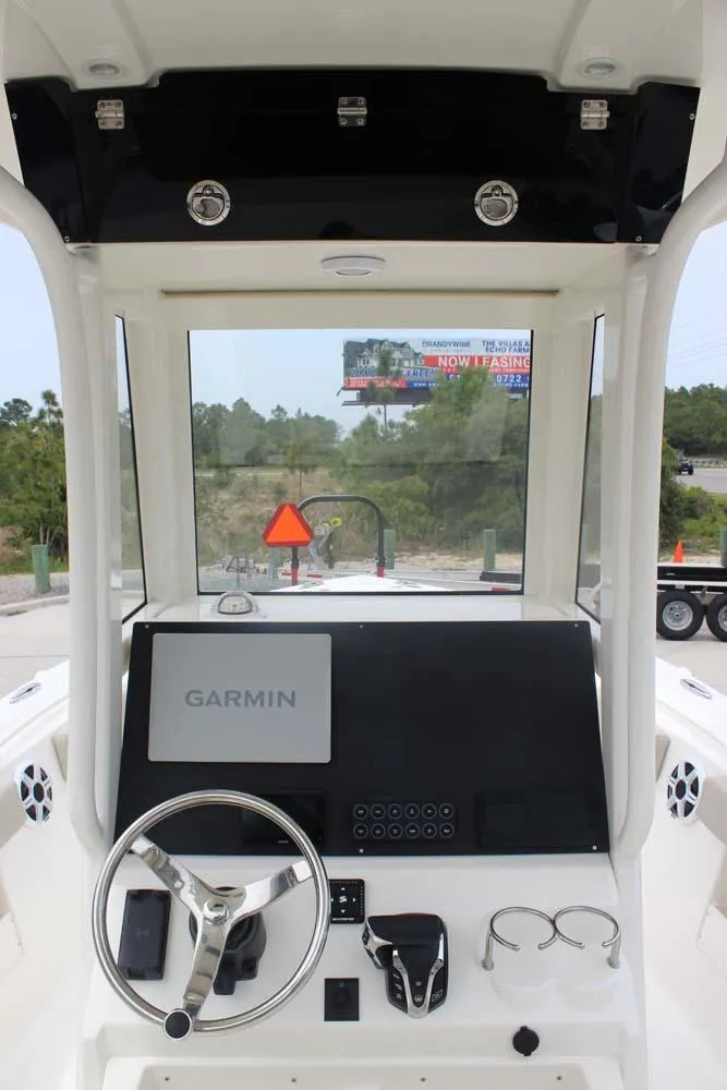 Slide: The Image of 2025 Key West 239 FSR boat dashboard with Garmin navigation system and steering wheel. - 7