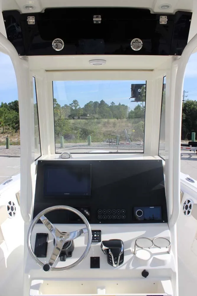 Slide: The Image of 2025 Key West 239 FSR boat dashboard with steering wheel and control panel. - 8