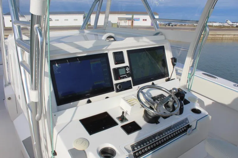 Slide: The Image of 2020 Invincible Center Cabin boat dashboard with advanced navigation controls and dual screens. - 3