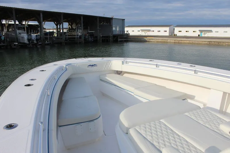 Slide: The Image of 2020 Invincible Center Cabin boat docked, featuring spacious seating and sleek design. - 7