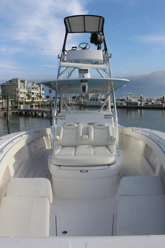 Slide: The Image of 2020 Invincible Center Cabin boat with spacious seating and elevated helm, docked at marina. - 9