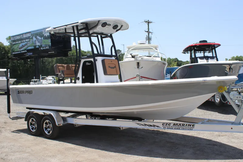 Slide: The Image of 2025 Sea Pro 230 Bay boat on trailer in marina setting. - 1