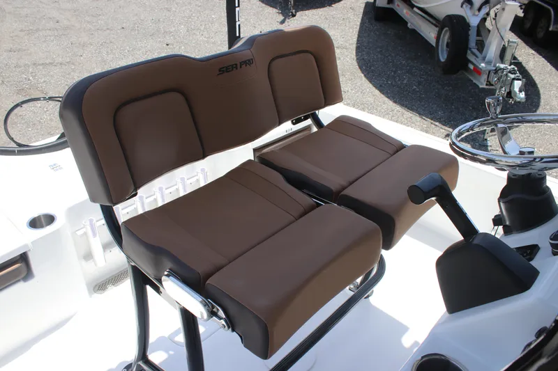 Slide: The Image of 2025 Sea Pro 230 Bay boat seats with brown cushions and steering wheel. - 15