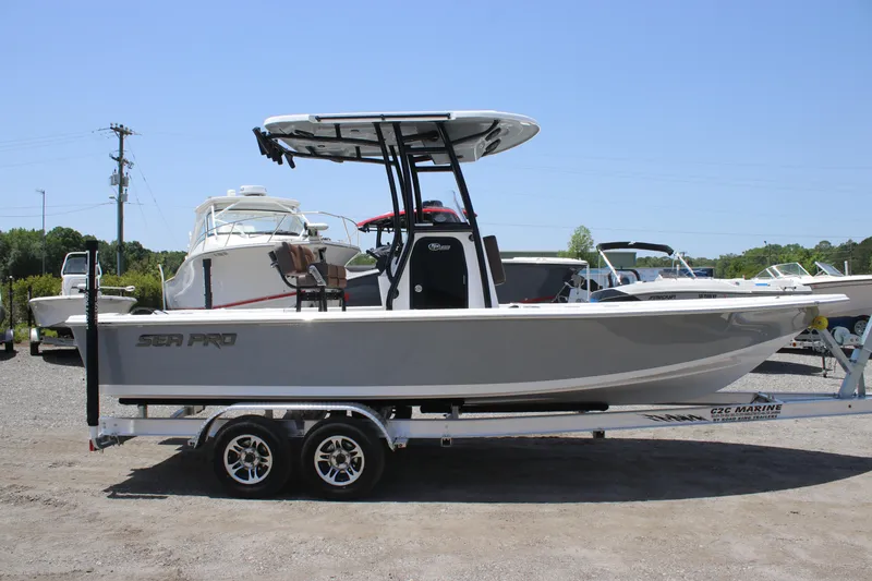 Slide: The Image of 2025 Sea Pro 230 Bay boat on trailer, side view, outdoors. - 2
