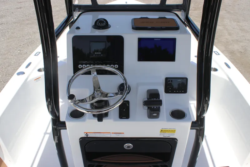Slide: The Image of 2025 Sea Pro 230 Bay boat console with steering wheel and navigation controls. - 4