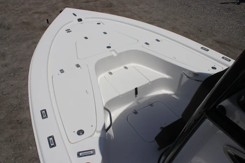 Slide: The Image of 2025 Sea Pro 230 Bay boat deck with storage compartments and seating area. - 5