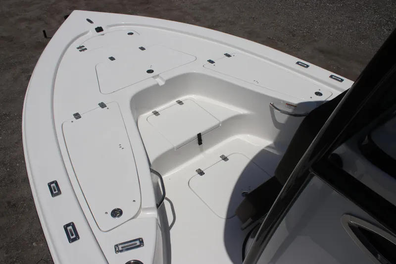 Slide: The Image of 2025 Sea Pro 230 Bay boat deck with storage compartments and seating area. - 9