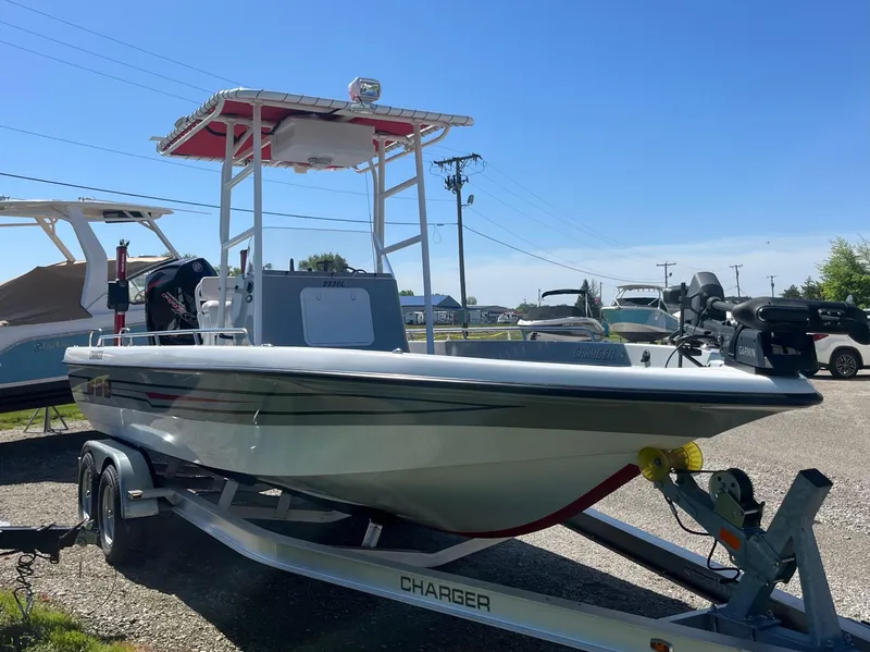 Slide: The Image of 2023 Charger 2230 L Sport boat on trailer in sunny outdoor setting. - 11