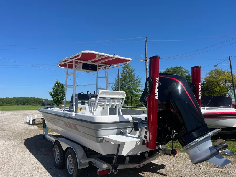 Slide: The Image of 2023 Charger 2230 L Sport boat on trailer with outboard motor, sunny day. - 3