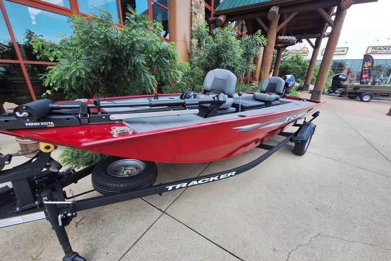 The Image of 2025 Tracker Panfish 17 boat in vibrant red on a trailer, displayed outdoors. - 0