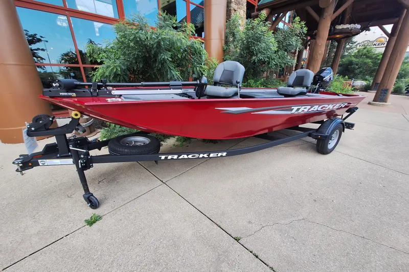 Slide: The Image of 2025 Tracker Panfish 17 boat in vibrant red on a trailer, parked outdoors. - 3