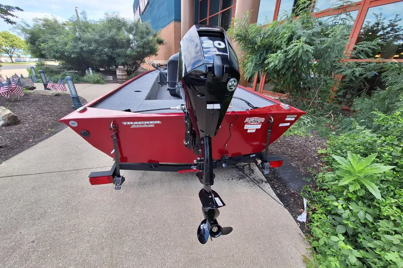 Slide: The Image of 2025 Tracker Panfish 17 boat with Mercury 20HP motor, parked outdoors. - 4