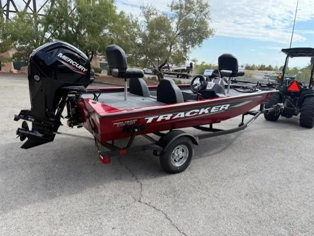 Slide: The Image of 2025 Tracker Pro Team 175 boat with Mercury engine, parked outdoors. - 2