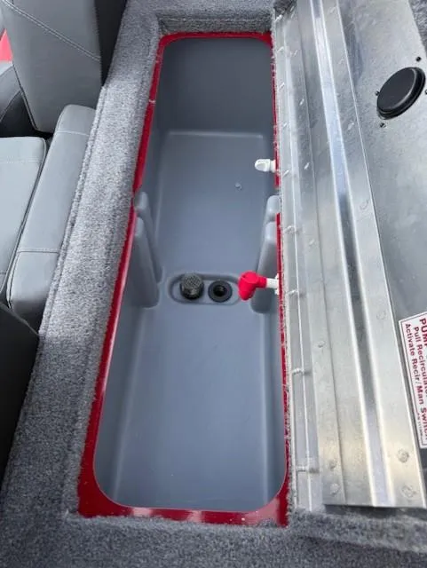 Slide: The Image of 2025 Tracker Pro Team 175 boat storage compartment with gray interior and red trim. - 5